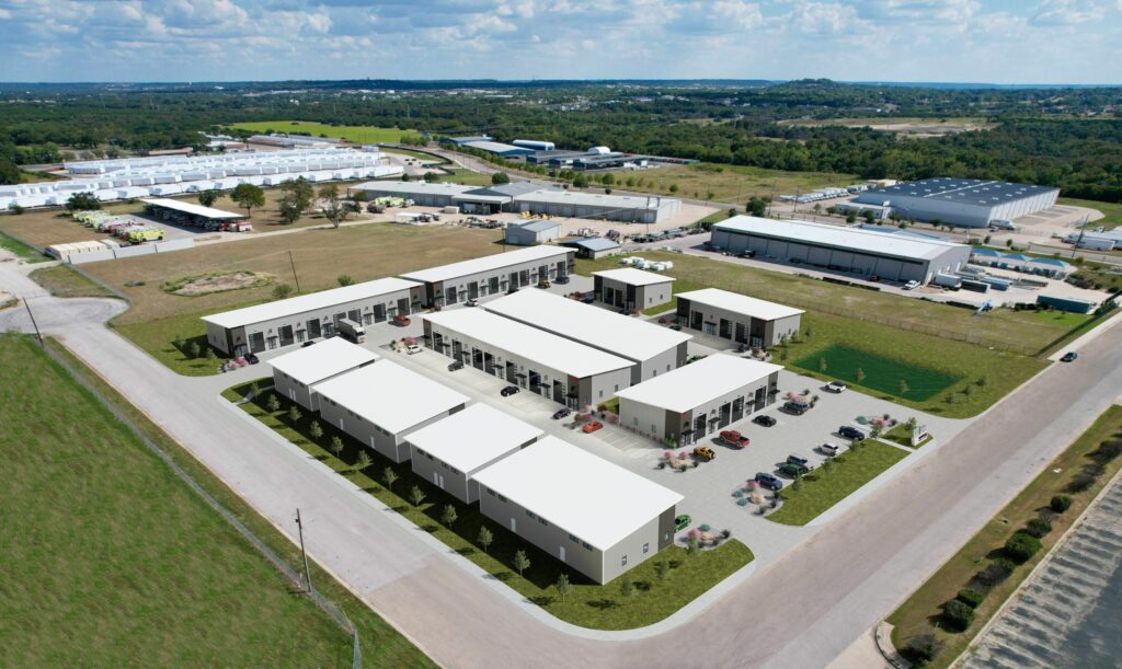 Aerial view of office/warehouse flex spaces buildings with surrounding streets, parking lots, and nearby infrastructure.